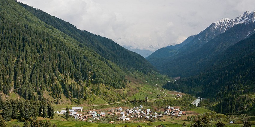 A view of Aru Valley from a vantage point shows a small village surrounded by large hills, one of the popular valleys in Kashmir.