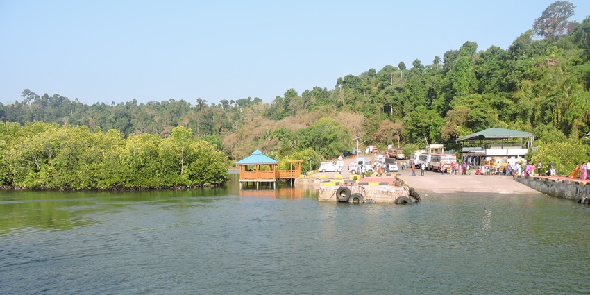 Small dock with wooden shack and forested backdrop on Baratang Island in the islands in the Andaman.