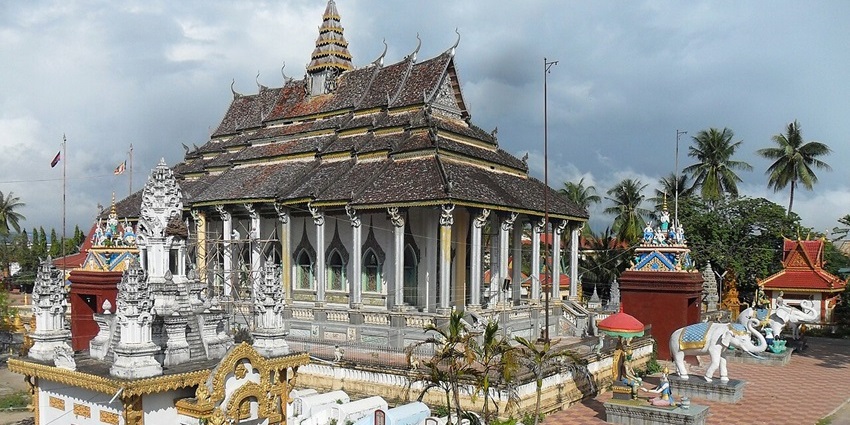A serene Buddhist temple surrounded by greenery in Battambang, Cambodia.