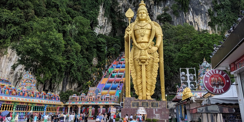 Batu Caves is a limestone hill with a vibrant staircase and a Golden Lord Murugan statue, a top destination among caves in Malaysia.
