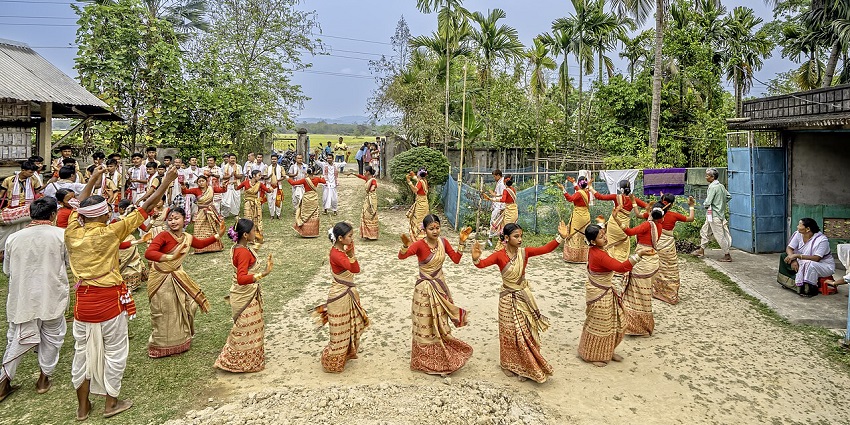 Young girls in sarees perform the Bihu Dance during celebrations, festivals in North East India.
