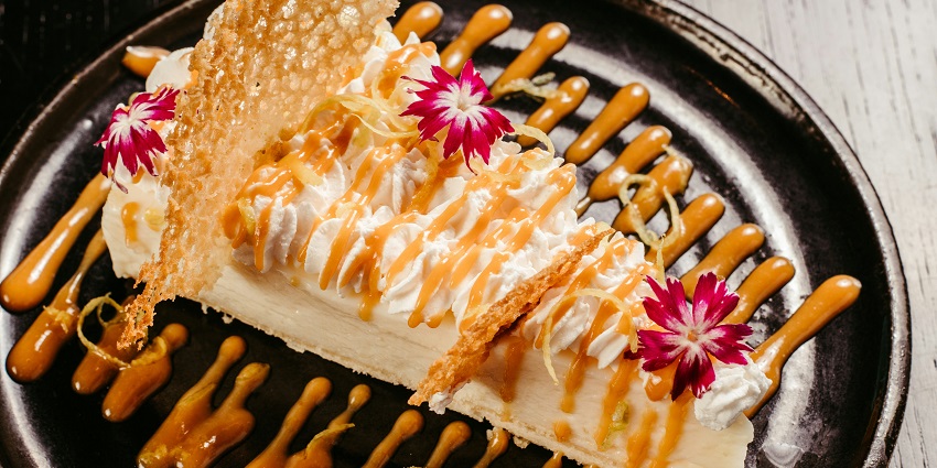 Durian cheesecake served at Bijan Bar & Restaurant on an elegant dessert plate.