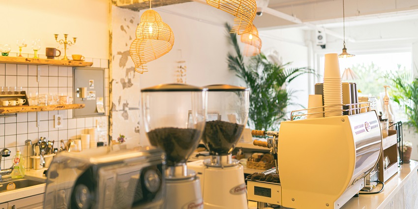 Cosy interior of Brewbeans Cafe with a coffee machine and warm lighting, one of the stunning cafes in Port Blair.