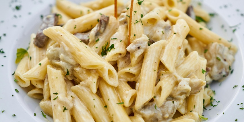 Creamy pasta served with herbs at Brewberry – The Rooftop Lounge.
