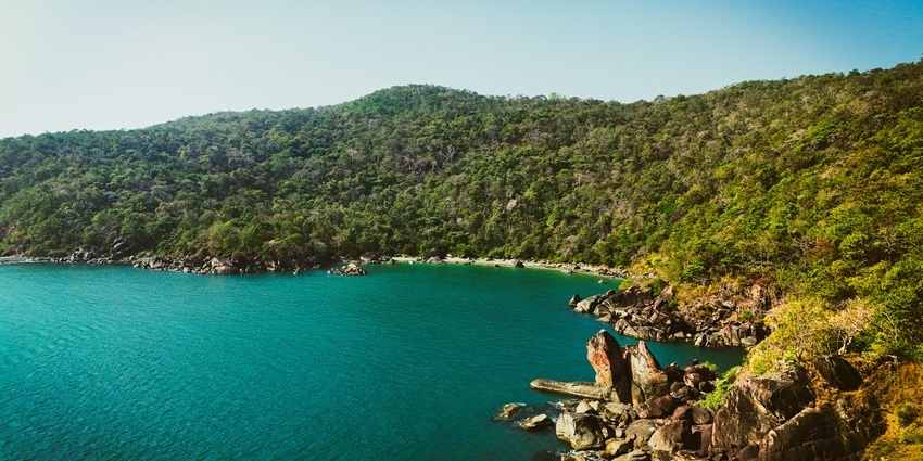 Scenic view of Butterfly Island with rocky shores and lush greenery – Islands in Goa.