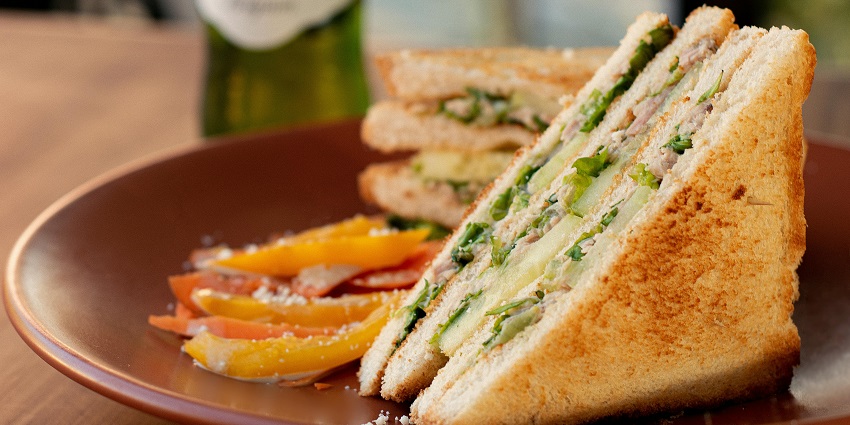 A club sandwich with fresh lettuce at Storytellers Café, one of the top cafes in Siliguri.
