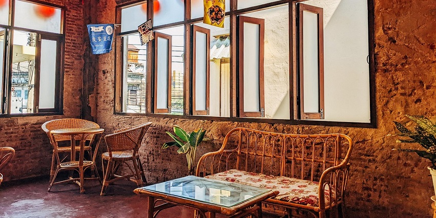 Small café in Siliguri with bright wall colours, warm lighting, and simple seating.
