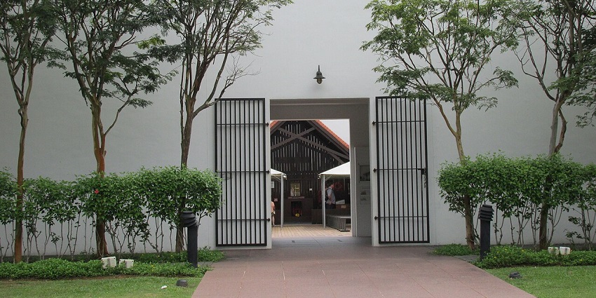Singapore’s Changi Museum entrance showing open black gates and courtyard path, one of the popular museums in Singapore.