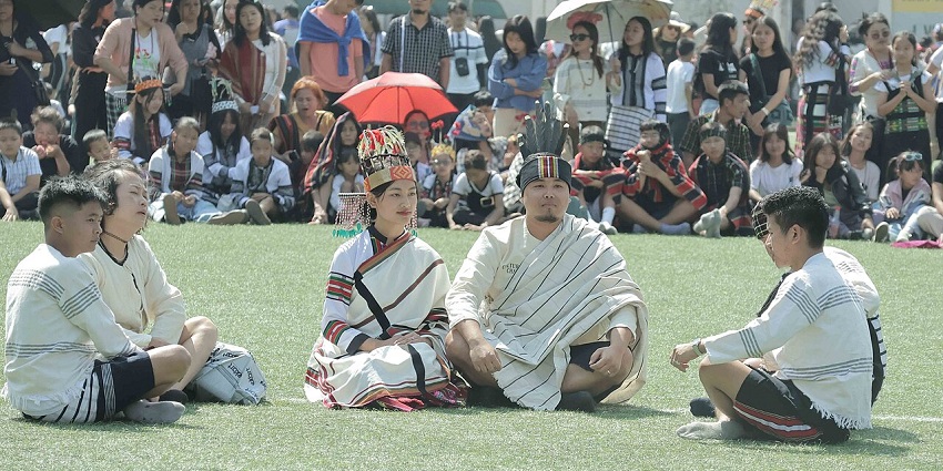 A Mizo man and woman sit during a performance at Chapchar Kut, festivals in North East India
