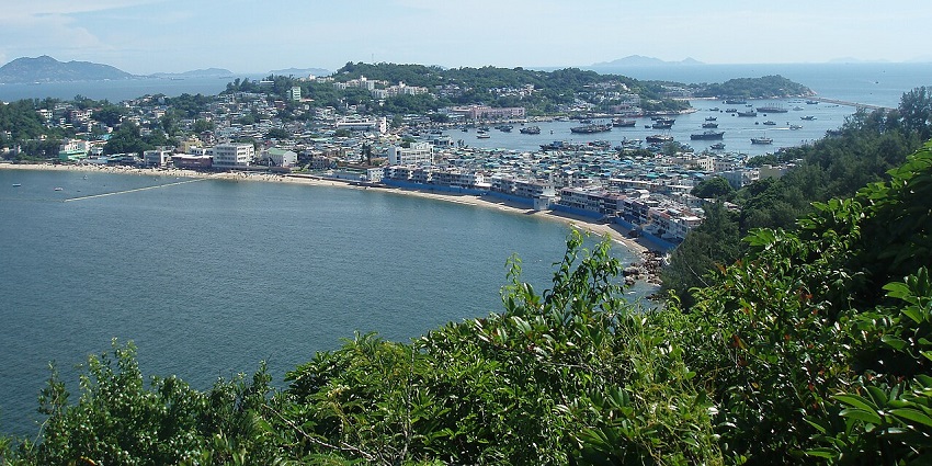 Cheung Chau Island from a distance with the town centre surrounded by water and boats.
