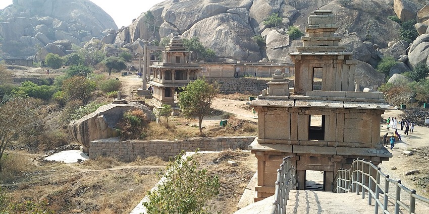 Ancient stone gateway and rocky landscape of Chitradurga Fort with visitors nearby, one of the top forts in Karnataka.