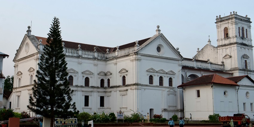 Chapel of Sacra Familia on Chorao Island in Goa, with a white facade and a cross on top.