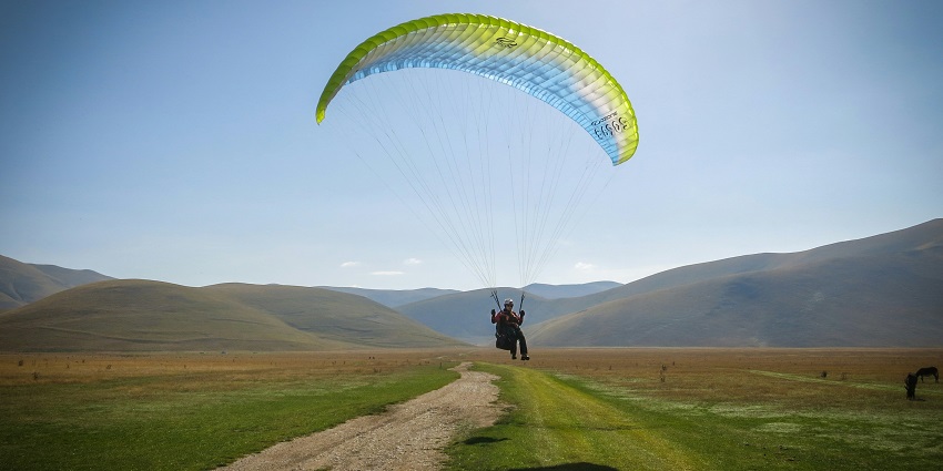 Paragliding in Karnataka at Coorg with breathtaking views of hills, forests, and valleys.