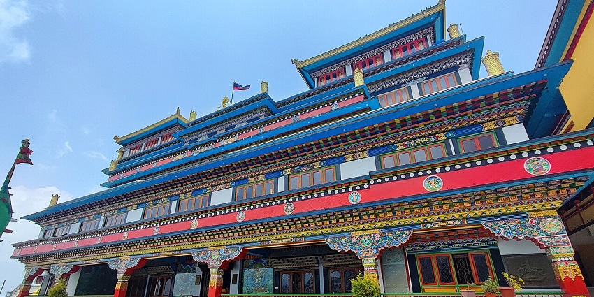 Druk sangag choling monastery with vibrant architectural building and green plants in the pot.