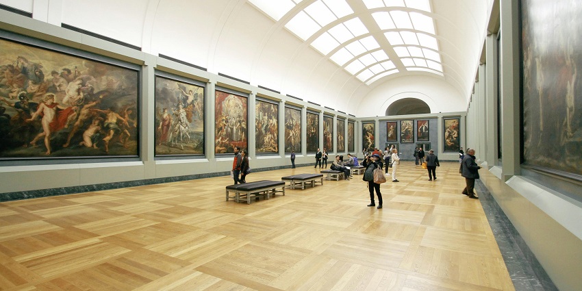 Interior view of David Hall Gallery & Cafe with visitors exploring the paintings on display.