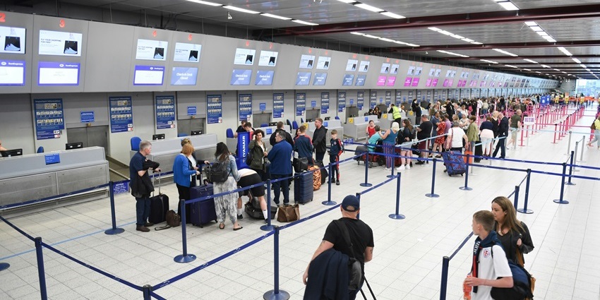 Interior of Donyi Polo Airport with people near the check-in counter and departure area.