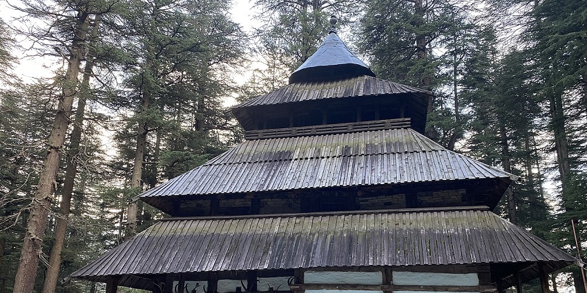 Tourists stand in front of the Hadimba Devi Temple in Manali, a popular destination during festivals in Himachal Pradesh.
