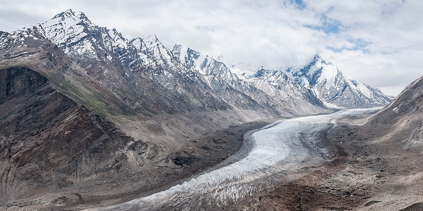 A long glacier in a rocky valley with snowy peaks, one of the national parks in Ladakh.
