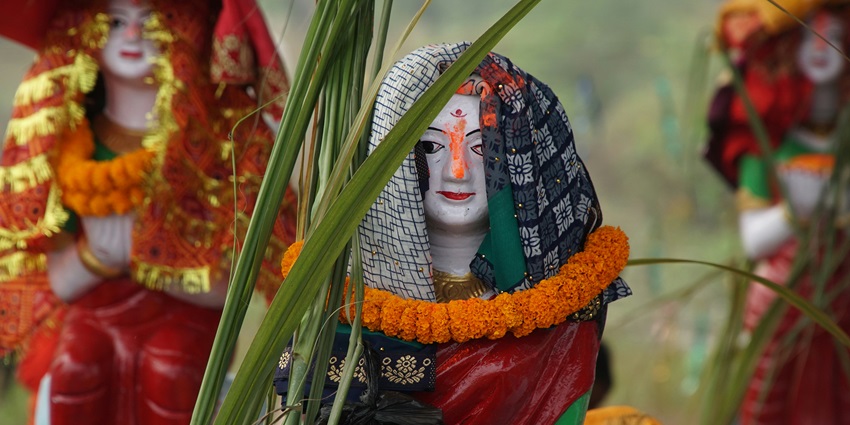 Decorated Chhath Puja idol adorned with flowers and traditional festive elements.