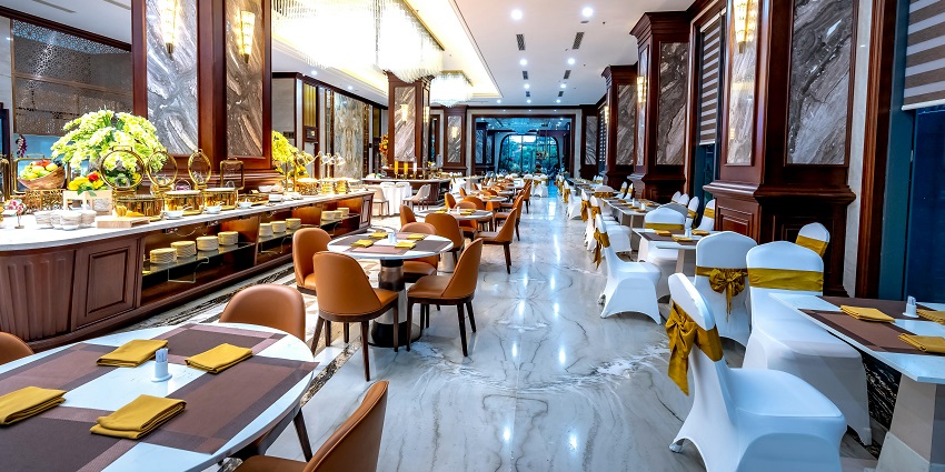 Modern luxury restaurant with marble flooring, buffet counters, and elegant seating, one of the top restaurants in Chinatown.
