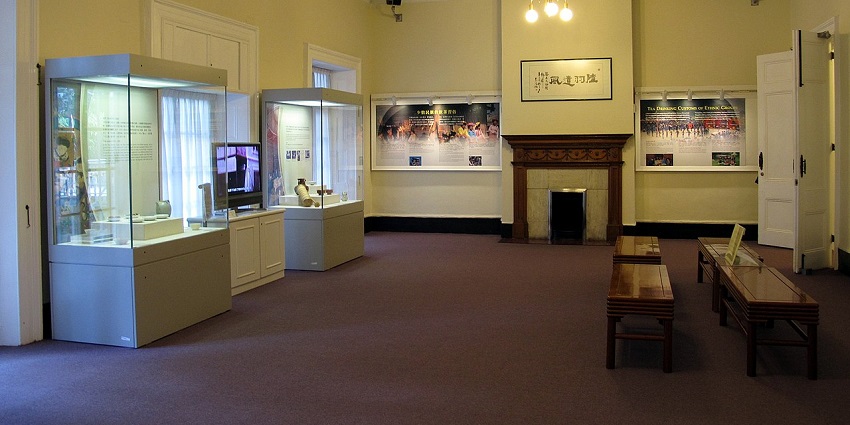 Interior of Flagstaff House Museum of Tea Ware with displays, benches, and a fireplace, one of the museums in Hong Kong.