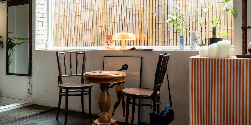 Folk Heritage Restaurant interior with table, chair, and window, one of the best restaurants in Thimphu.
