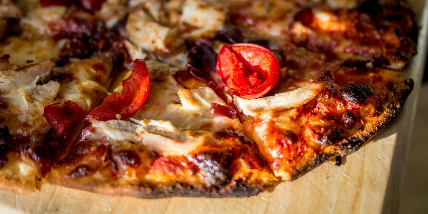 Cheesy pizzas served on plates at one of the popular restaurants in Siliguri.
