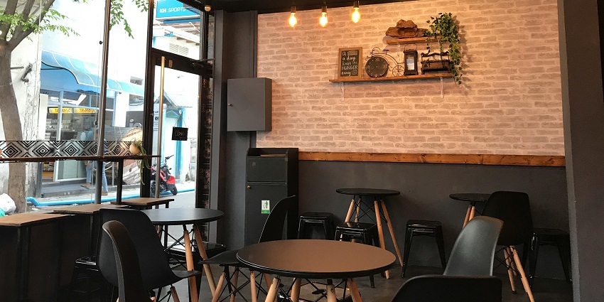 Cosy interior of Gagan Restaurant featuring warm lighting, wooden tables, and chairs.