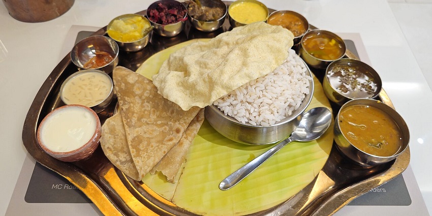 The Vegetarian Thali serves puris, rice, fried rice, buttermilk, and a dish called sheera, in one of the pure veg restaurants in Siliguri.