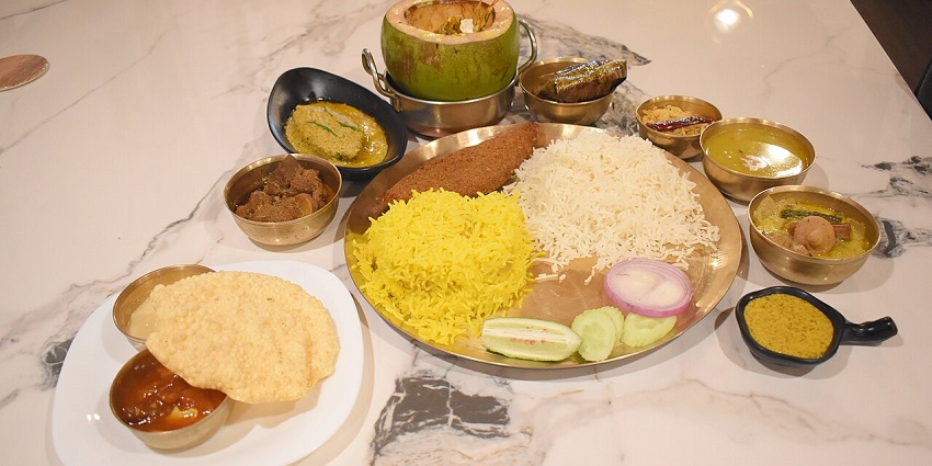 The Vegetarian Thali serves puris, rice, fried rice, buttermilk, and a dish called sheera, in one of the pure veg restaurants in Siliguri.