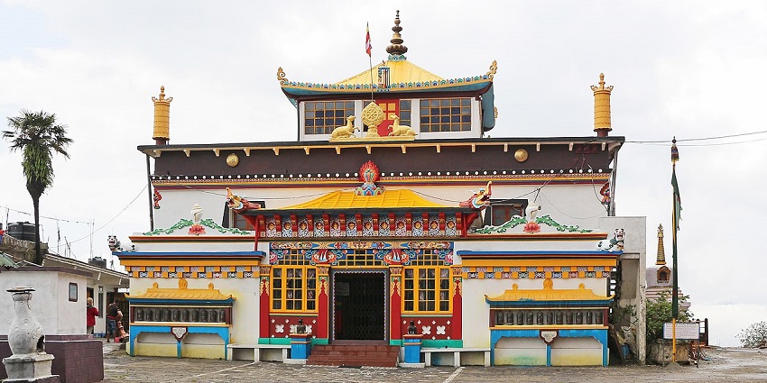 Yiga Choeling monastery in Darjeeling with colourful architectural building and a flag on top.