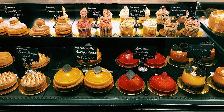 A shelf full of assorted cakes at Glenary's Restaurant, Darjeeling.
