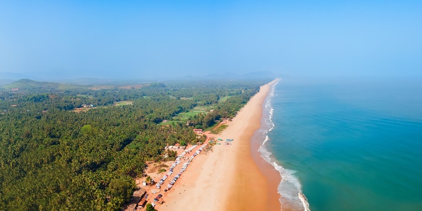 Aerial view of Gokarna beaches with golden sands and waves at picnic places in Karnataka.