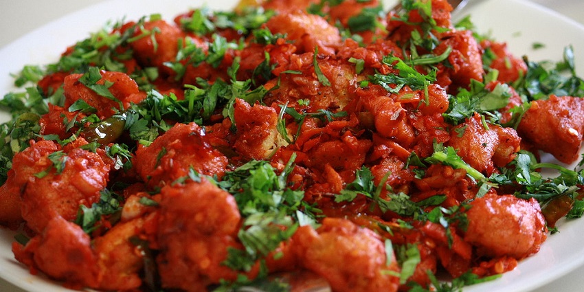 A plate full of amazing local dishes of Siliguri, like roomali roti and butter masala.
