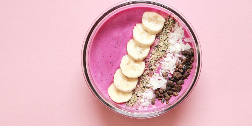 Smoothie bowl topped with banana slices and seeds at Grains Pure Veg By Udaan Alpine.