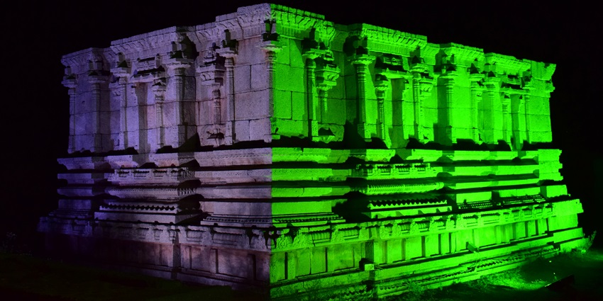 Ancient monument in Hampi beautifully lit up, showcasing heritage during a festival.