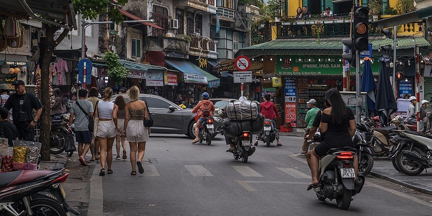 Shoppers, with some of them tourists, throng the streets of Hanoi Old Quarter in Vietnam.
