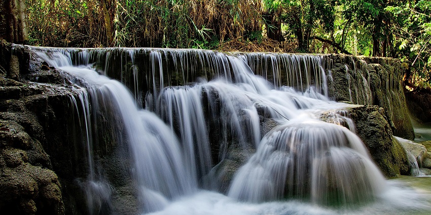 Harvalem Waterfall is surrounded by lush greenery and rocky cliffs, one of the popular waterfalls in Goa.
