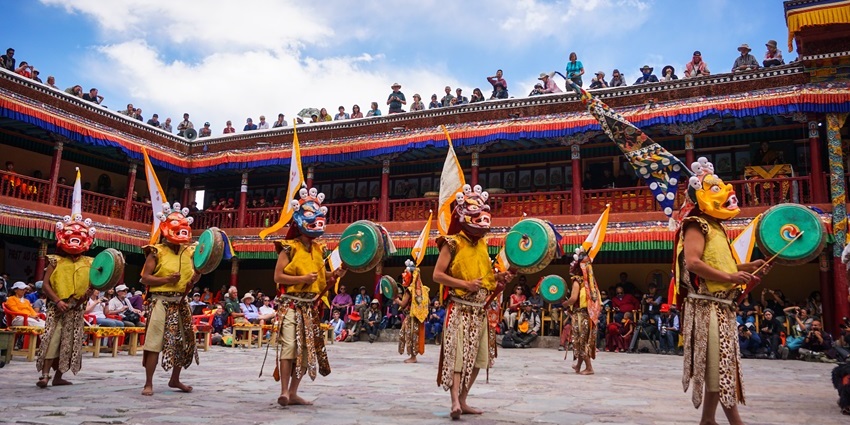 Monks in vibrant costumes perform Cham dance at Hemis Festival during festivals in Ladakh.