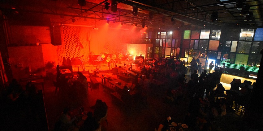 A lively band performs at a dimly lit bar, with a crowd enjoying the music and atmospherein one of the restaurants in City Centre Siliguri.
