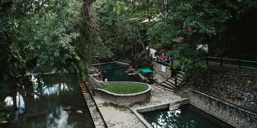 Relaxing natural pools at Hin Dad Hot Spring are nestled in forest, one of the hot springs in Thailand.