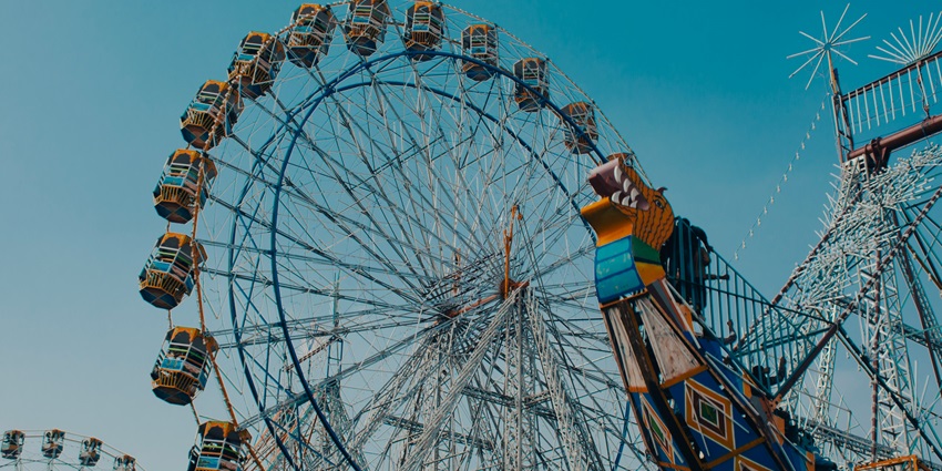 A large ferris wheel spinning with bright lights at Pushkar Mela in Rajasthan.