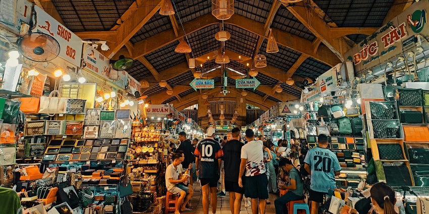 People roam a night market in Vietnam with street food vendors, perfect for shopping in Vietnam.

