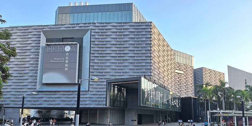 Front view of the Hong Kong Museum of Art with visitors walking across the plaza, one of the popular museums in Hong Kong.