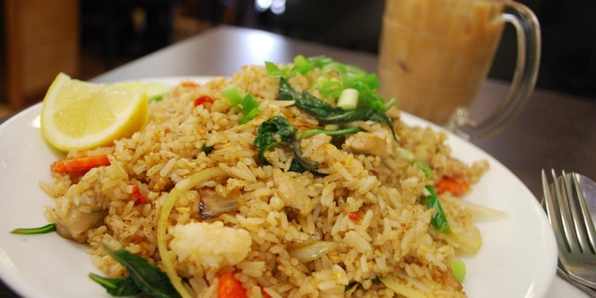 Stir-fried rice with chicken, vibrant basil leaves, veggies, and egg served at one of the top restaurants in Jayanagar Guwahati.