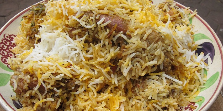 A large platter piled high with a generous serving of delicious, aromatic chicken biryani, in one of the Indian restaurants in Kuala Lumpur.
