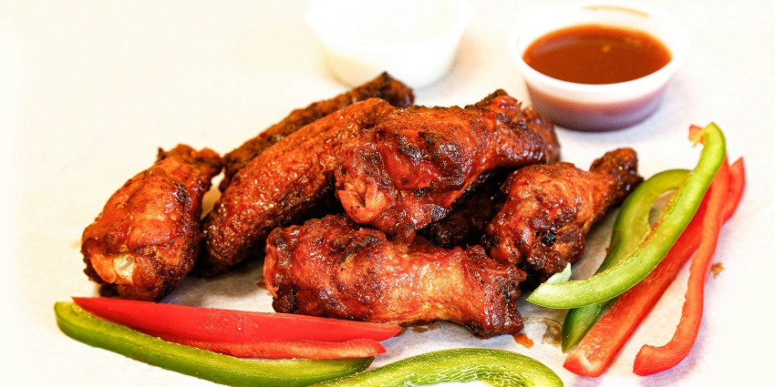 BBQ chicken wings served at Jalan Alor, a must-try at the best restaurants in Kuala Lumpur.