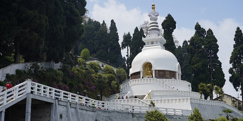 Japanese Peace Pagoda in Darjeeling with white architectural dome and visitors, one of the offbeat places in Darjeeling.