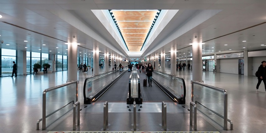 Kalaburagi Airport corridor with people walking through the terminal area.