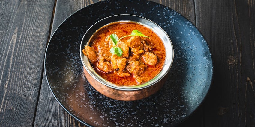 Rich and creamy butter chicken served hot at Kalita Spectrum restaurant.